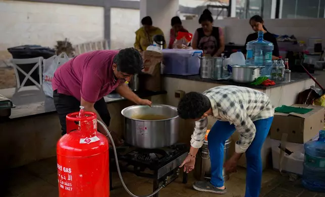 Farmhouse staff prepare food for stranded Indian travelers at a farmhouse owned by an Indian businessman, now converted into a shelter in Ajman, near Dubai, United Arab Emirates, Saturday, March 7, 2026. (AP Photo/Altaf Qadri)