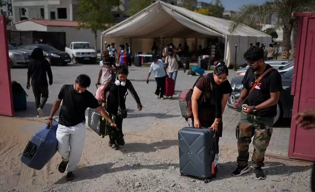 Stranded foreign travelers depart the farmhouse owned by an Indian businessman, now converted into a shelter, in Ajman, near Dubai, United Arab Emirates, Saturday, March 7, 2026. (AP Photo/Altaf Qadri)