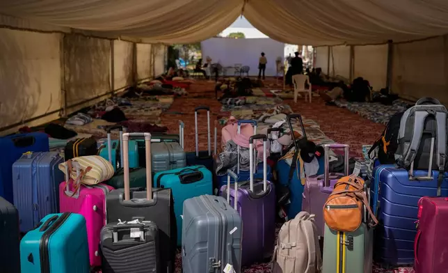 Suitcases belonging to stranded foreign travelers are seen at a farmhouse owned by an Indian businessman, now converted into a shelter in Ajman, near Dubai, United Arab Emirates, Saturday, March 7, 2026. (AP Photo/Altaf Qadri)