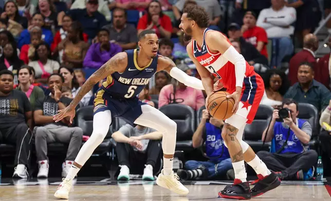 Washington Wizards guard Trae Young (3) tries to make a move against New Orleans Pelicans guard Dejounte Murray (5) in the first half of an NBA basketball game in New Orleans, Sunday, March 8, 2026. (AP Photo/Peter Forest)