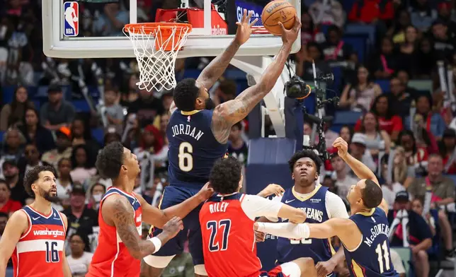 New Orleans Pelicans center DeAndre Jordan (6) pulls down a defensive rebound over Washington Wizards guard Will Riley (27) in the first half of an NBA basketball game in New Orleans, Sunday, March 8, 2026. (AP Photo/Peter Forest)