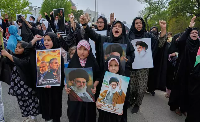 Shiite Muslim women and children take part in a rally to condemn the killing of Iranian Supreme Leader Ayatollah Ali Khamenei and against the Israeli strikes on Iran, in Islamabad, Pakistan, Friday, March 6, 2026. (AP Photo/Anjum Naveed)