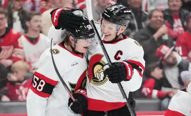 Ottawa Senators left wing Brady Tkachuk, right, celebrates his goal with Carter Yakemchuk, left, against the Detroit Red Wings in the first period of an NHL hockey game Tuesday, March 24, 2026, in Detroit. (AP Photo/Paul Sancya)