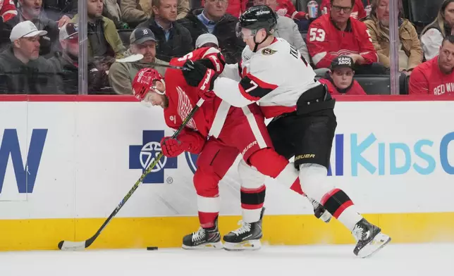 Ottawa Senators left wing Brady Tkachuk (7) checks Detroit Red Wings right wing Alex DeBrincat (93) off the puck in the first period of an NHL hockey game Tuesday, March 24, 2026, in Detroit. (AP Photo/Paul Sancya)