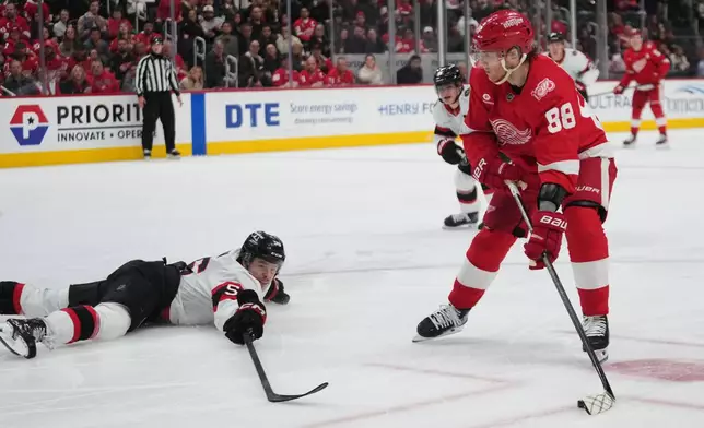 Ottawa Senators defenseman Jorian Donovan (56) defends Detroit Red Wings right wing Patrick Kane (88) in the second period of an NHL hockey game Tuesday, March 24, 2026, in Detroit. (AP Photo/Paul Sancya)