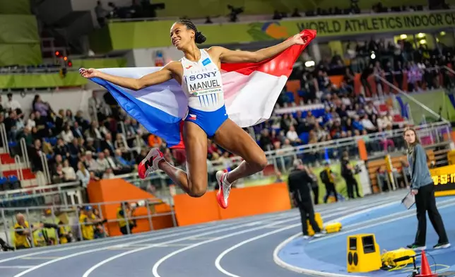 Lurdes Gloria Manuel, of Czechia, celebrates after winning the gold medal in the women's 400 meters final at the World Athletics Indoor Championships in Torun, Poland, Saturday, March 21, 2026. (AP Photo/Petr David Josek)