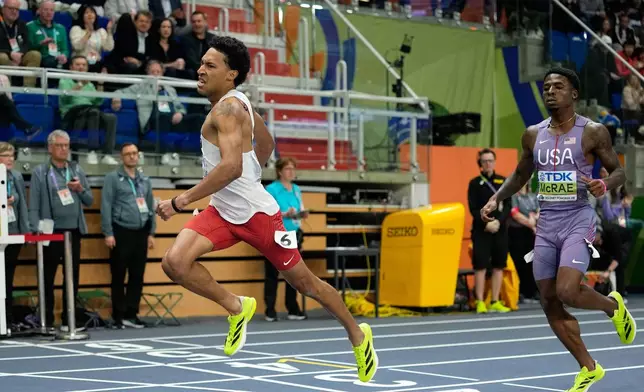 Christopher Morales Williams, of Canada, crosses the finish line to win the gold medal, ahead of silver medalist Khaleb McRae, of the United States, in the men's 400 meters final at the World Athletics Indoor Championships in Torun, Poland, Saturday, March 21, 2026.(AP Photo/Matthias Schrader)