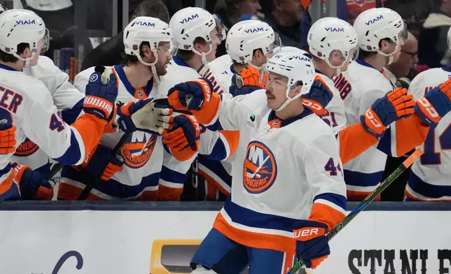 New York Islanders center Jean-Gabriel Pageau is congratulated by teammates after a goal in the second period of an NHL hockey game against the Columbus Blue Jackets in Columbus, Ohio, Saturday, Feb. 28, 2026. (AP Photo/Sue Ogrocki)