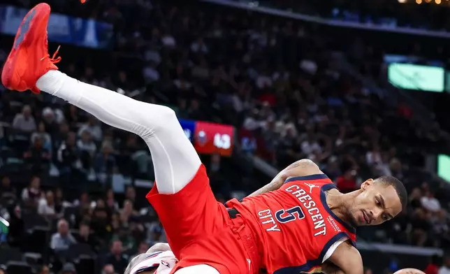 New Orleans Pelicans guard Dejounte Murray (5) falls on Los Angeles Clippers guard Bennedict Mathurin, below, after dunking during the first half of an NBA basketball game, Sunday, March 1, 2026, in Inglewood, Calif. (AP Photo/Jessie Alcheh)