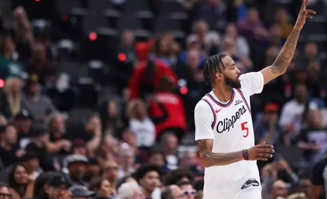 Los Angeles Clippers forward Derrick Jones Jr. gestures after making a 3-point basket during the first half of an NBA basketball game against the New Orleans Pelicans, Sunday, March 1, 2026, in Inglewood, Calif. (AP Photo/Jessie Alcheh)