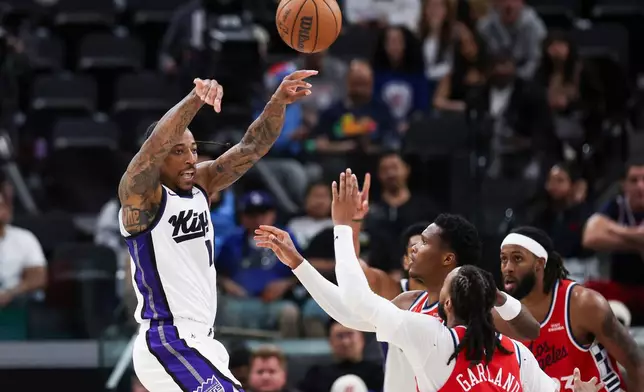 Sacramento Kings guard DeMar DeRozan, left, passes the ball against Los Angeles Clippers guard Darius Garland, front center, and guard Bennedict Mathurin, back center, as forward Isaiah Jackson, back right, watches during the second half of an NBA basketball game, Saturday, March 14, 2026, in Inglewood, Calif. (AP Photo/Jessie Alcheh)