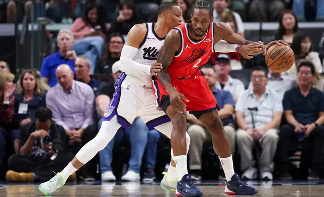 Los Angeles Clippers forward Kawhi Leonard (2) dribbles against Sacramento Kings guard Russell Westbrook, left, during the first half of an NBA basketball game, Saturday, March 14, 2026, in Inglewood, Calif. (AP Photo/Jessie Alcheh)