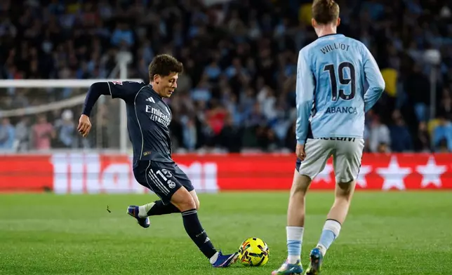 Real Madrid's Arda Guler, left, duels for the balls with Celta's Williot Swedberg during a Spanish La Liga soccer match between Celta Vigo and Real Madrid in Vigo, Spain, Friday, March 6, 2026. (AP Photo/Lalo R. Villar)