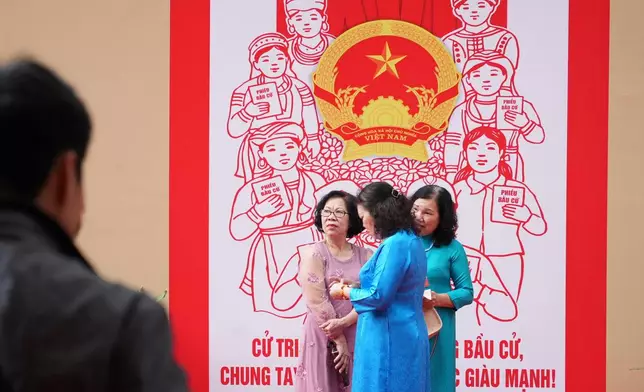 Voters wait to cast ballots to elect representatives in the National Assembly and people's councils in Hanoi, Vietnam, Sunday, March 15, 2026. (AP Photo/Hau Dinh)