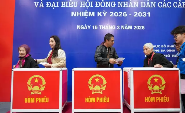 Voters cast ballots to elect representatives in the National Assembly and people's councils in Hanoi, Vietnam, Sunday, March 15, 2026. (AP Photo/Hau Dinh)