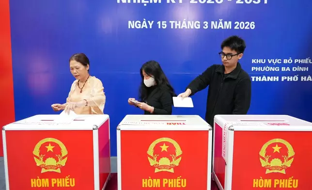 Voters cast ballots to elect representatives in the National Assembly and people's councils in Hanoi, Vietnam, Sunday, March 15, 2026. (AP Photo/Hau Dinh)
