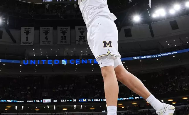 Michigan center Aday Mara dunks against Ohio State during the first half of an NCAA college basketball game in the quarterfinals of the Big 10 Conference tournament, Friday, March 13, 2026, in Chicago. (AP Photo/Nam Y. Huh)