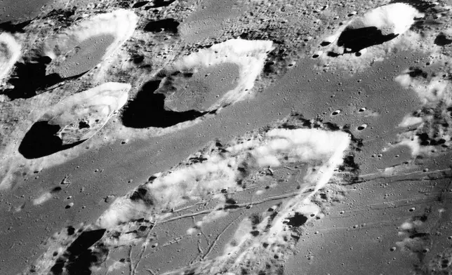 FILE - This Dec. 29, 1968, photo made available by NASA shows the large moon crater Goclenius, foreground, approximately 40 statute miles in diameter, and three clustered craters, Magelhaens, Magelhaens A and Colombo A, during the Apollo 8 mission. (NASA via AP, File)