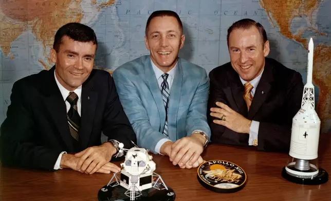 FILE - In this April 10, 1970, photo made available by NASA, Apollo 13 astronauts, from left, Fred Haise, Jack Swigert and Jim Lovell, gather for a photo on the day before launch. (NASA via AP, File)