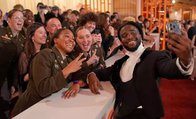 Shaboozey poses with fans as he arrives at the Oscars on Sunday, March 15, 2026, at the Dolby Theatre in Los Angeles. (AP Photo/John Locher)