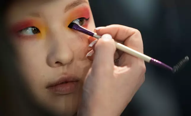 A model gets ready for a runway show at the backstage of the Moscow Fashion Week in Moscow, Saturday, March 14, 2026. (AP Photo/Pavel Bednyakov)