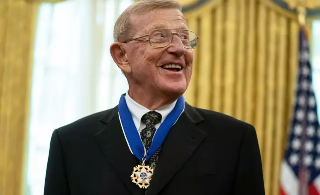 FILE - Former football coach Lou Holtz smiles after receiving the Presidential Medal of Freedom from President Donald Trump, Thursday, Dec. 3, 2020, in the Oval Office of the White House in Washington. (AP Photo/Evan Vucci, File)