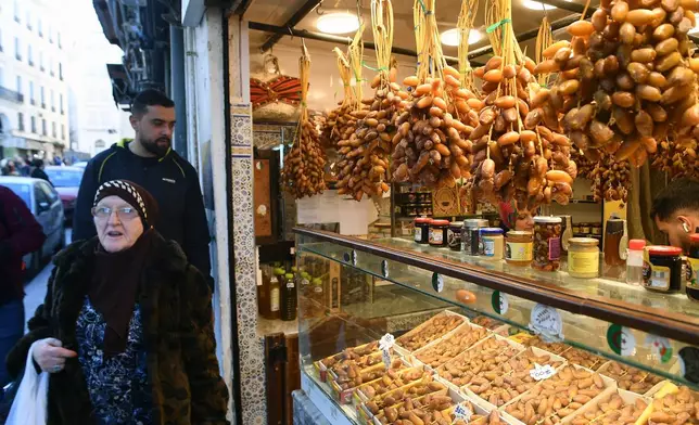 People stock up on food at a market in Algiers, Algeria, Thursday, Feb. 17, 2026, before the start of the holy month of Ramadan. (AP Photo/Fateh Guidoum)
