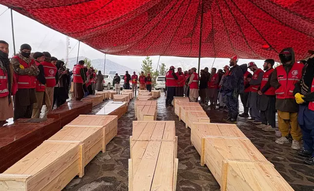 Coffins containing the remains of victims of a Monday airstrike on a drug rehabilitation hospital are laid out before burial in Kabul, Afghanistan, Wednesday, March 18, 2026. (AP Photo/Siddiqullah Alizai)