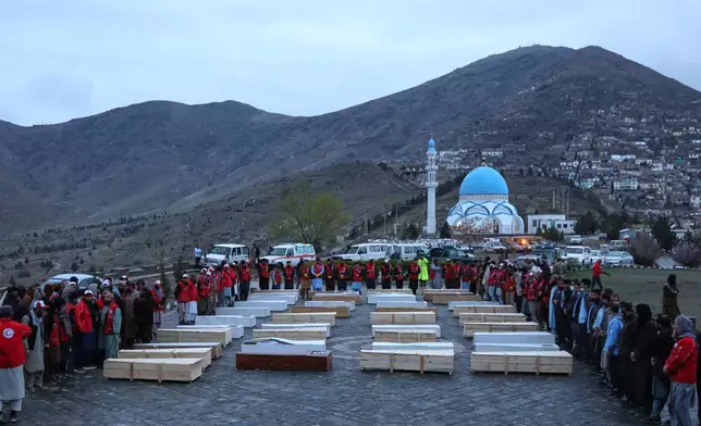 Coffins containing the remains of victims of a Monday airstrike on a drug rehabilitation hospital are laid out before burial in Kabul, Afghanistan, Wednesday, March 18, 2026. (AP Photo/Siddiqullah Alizai)