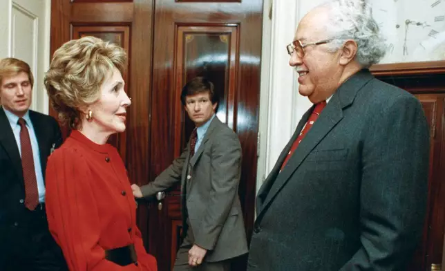 In this 1983 photo provided by The White House, John Woodson Ficklin talks with first lady Nancy Reagan at the White House in Washington. (The White House via AP)