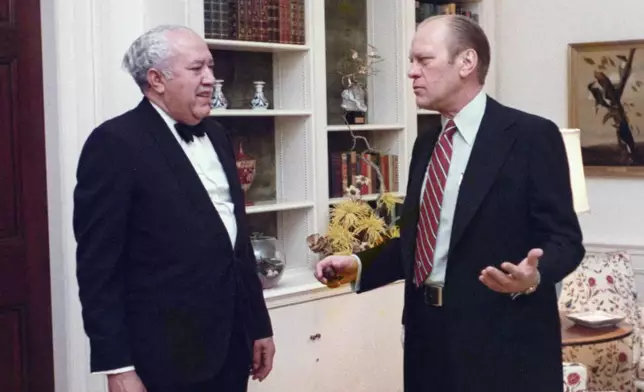 In this 1975 photo provided by The White House, President Gerald Ford speaks with John Woodson Ficklin in the residence of the White House in Washington. (White House Historical Association/The White House via AP)