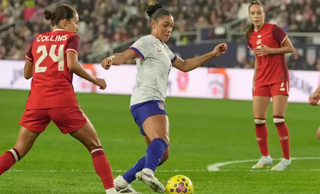 United States' Trinity Rodman, center, dribbles past Canada's Sydney Collins (24) in the first half of a SheBelieves Cup women's soccer match in Columbus, Ohio, Wednesday, March 4, 2026. (AP Photo/Sue Ogrocki)