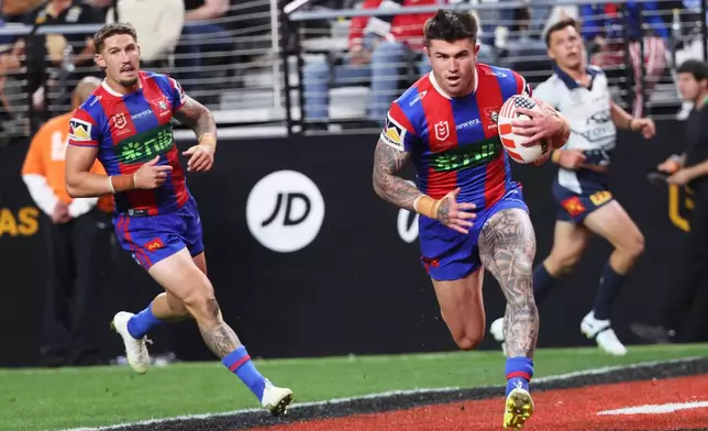 Newcastle Knights' Bradman Best runs to score try during the Australia National Rugby League game between the Newcastle Knights and the North Queensland Cowboys in Las Vegas, Saturday, Feb. 28, 2026. (AP Photo/Ian Maule)