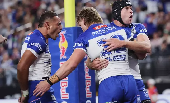 Bulldogs Jacob Preston, center, is congratulated by teammates after scoring a try during the Australia National Rugby League game between the Canterbury Bulldogs and the St George-Illawarra Dragons in Las Vegas, Saturday, Feb. 28, 2026. (AP Photo/Ian Maule)