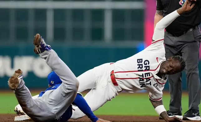 Britain's Jazz Chisholm Jr., right, is tagged out while trying to steal second base by Brazil shortstop Vitor Ito, left, during the seventh inning of a World Baseball Classic game, Monday, March 9, 2026, in Houston. (AP Photo/David J. Phillip)