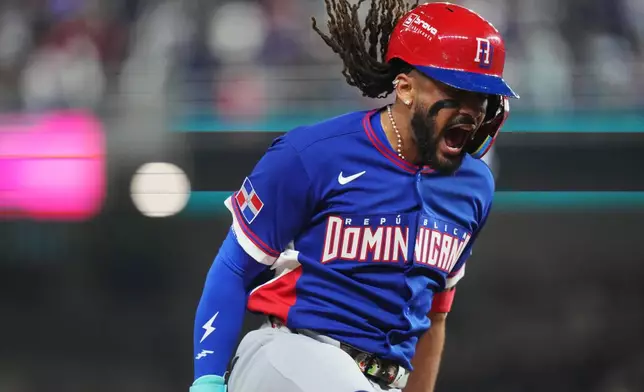 Dominican Republic's Fernando Tatis Jr. celebrates as he runs the bases after hitting a three-run home run during the fourth inning of a World Baseball Classic game against Venezuela, Wednesday, March 11, 2026, in Miami. (AP Photo/Lynne Sladky)