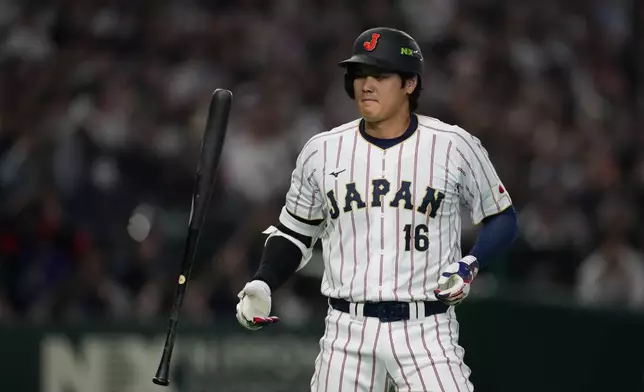 Japan's Shohei Ohtani reacts after a foul ball during the first inning of a World Baseball Classic game between Japan and South Korea on Saturday, March 7, 2026 in Tokyo, Japan. (AP Photo/Hiro Komae)