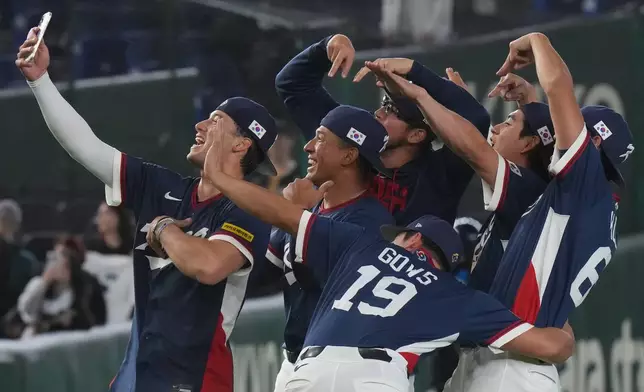 South Korea players take a selfie as they celebrate after defeating Australia in their World Baseball Classic game on Monday, March 9, 2026 in Tokyo. (AP Photo/Eugene Hoshiko)
