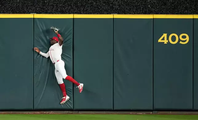 Canada outfielder Denzel Clarke catches a fly hit by United States first baseman Bryce Harper (24) during the first inning of a World Baseball Classic quarterfinal game, Friday, March 13, 2026, in Houston. (AP Photo/David J. Phillip)