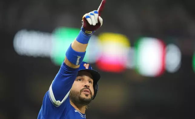 Venezuela designated hitter Eugenio Suárez gestures after hitting a home run during the fourth inning of a World Baseball Classic semifinal game against Italy, Monday, March 16, 2026, in Miami. (AP Photo/Rebecca Blackwell)