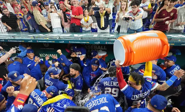 The Venezuela team celebrates after defeating Italy at a World Baseball Classic semifinal game, Monday, March 16, 2026, in Miami. (AP Photo/Rebecca Blackwell)