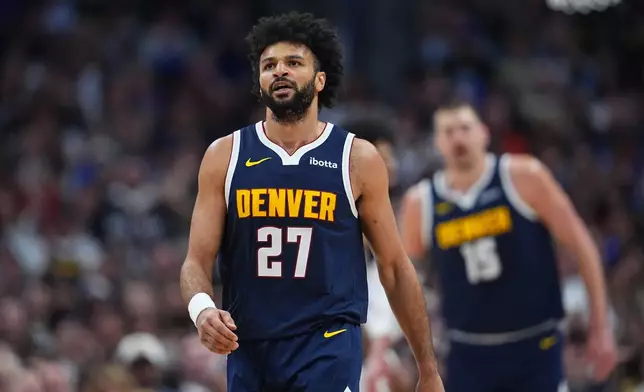 Denver Nuggets guard Jamal Murray reacts after hitting a basket and drawing a foul in the first half of an NBA basketball game against the Dallas Mavericks Wednesday, March 25, 2026, in Denver. (AP Photo/David Zalubowski)