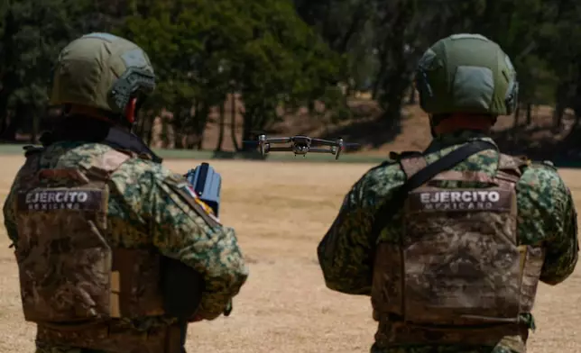 Soldiers from the Mexican Army's anti-drone squadron display the equipment and tactics they will use during the 2026 FIFA World Cup, during a media presentation in Mexico City, Friday, Feb. 27, 2026. (AP Photo/Marco Ugarte)