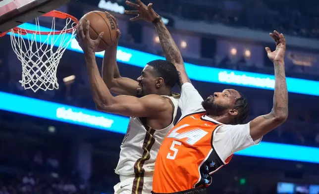 Golden State Warriors guard De'Anthony Melton, left, grabs a rebound against Los Angeles Clippers forward Derrick Jones Jr. (5) during the first half of an NBA basketball game in San Francisco, Monday, March 2, 2026. (AP Photo/Jeff Chiu)