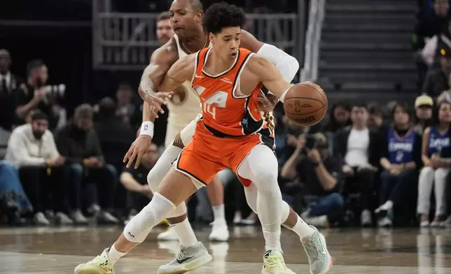 Los Angeles Clippers center Yanic Konan Niederhäuser, foreground, controls the ball against Golden State Warriors center Al Horford during the first half of an NBA basketball game in San Francisco, Monday, March 2, 2026. (AP Photo/Jeff Chiu)