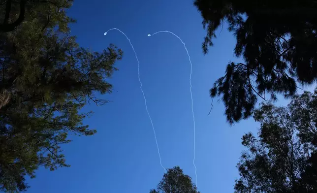 Israeli air defense systems fire to intercept projectiles launched from Lebanon over northern Israel, Tuesday, March 17, 2026. (AP Photo/Ariel Schalit)