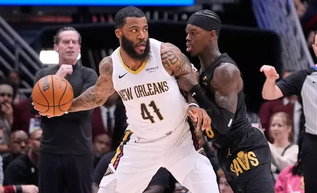 New Orleans Pelicans guard Saddiq Bey (41) works the ball against Cleveland Cavaliers guard Dennis Schroder (8) in the first half of an NBA basketball game, Saturday, March 21, 2026, in New Orleans. (AP Photo/Gerald Herbert)