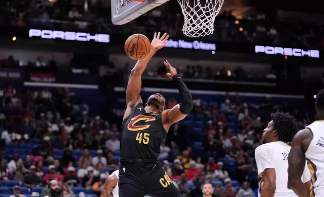Cleveland Cavaliers guard Donovan Mitchell (45) loses the ball as he is fouled while driving to the basket against the New Orleans Pelicans in the first half of an NBA basketball game, Saturday, March 21, 2026, in New Orleans. (AP Photo/Gerald Herbert)