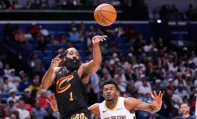 Cleveland Cavaliers guard James Harden (1) passes around New Orleans Pelicans center Yves Missi in the first half of an NBA basketball game, Saturday, March 21, 2026, in New Orleans. (AP Photo/Gerald Herbert)