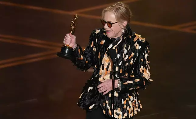 Amy Madigan accepts the award for actress in a supporting role for "Weapons" during the Oscars on Sunday, March 15, 2026, at the Dolby Theatre in Los Angeles. (AP Photo/Chris Pizzello)